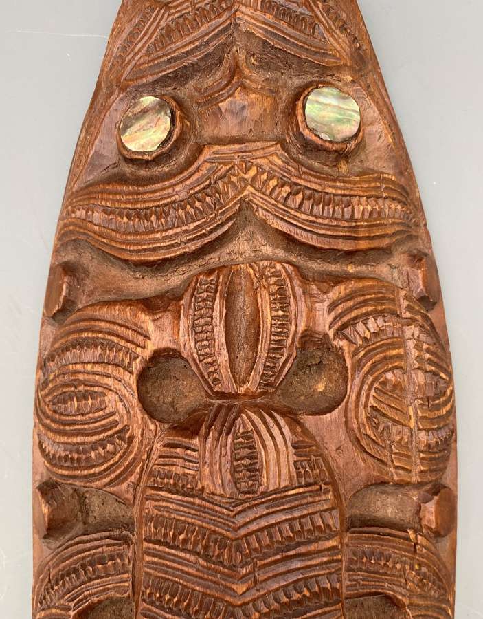 Maori short dance paddle decorated with figures New Zealand