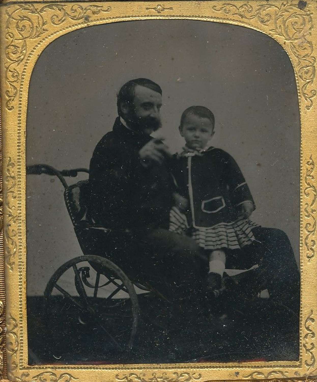 1/6 Plat ambrotype of a Gentlemen in A Wheelchair with a Child