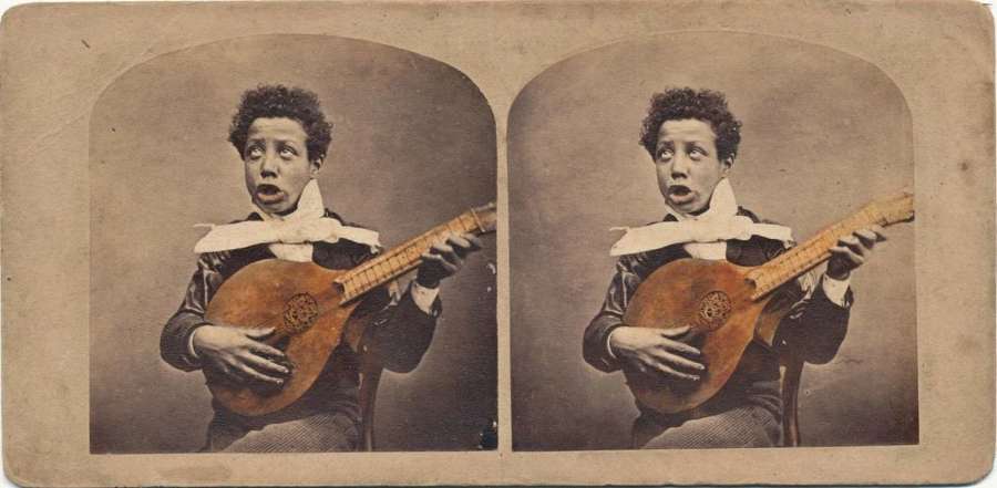 Stereoview of Black Man Play Old English Guitar  C1870